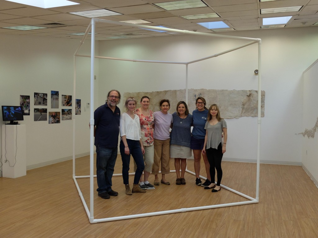 Seven of eight staff joining in the vegan challenge stand inside Michelle Wilson's "Carbon Corpus." Left to right: Mike Weilbacher, Jenny Ryder, Michelle Havens, Patty Boyle, Donna Struck, Emily Harkness, Elisabeth Zafiris. Not pictured: Christina Catanese