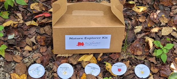 A Schuylkill Center nature kit on the leaf-covered ground