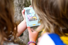 Two kids looking at an Aqua-Marooned card