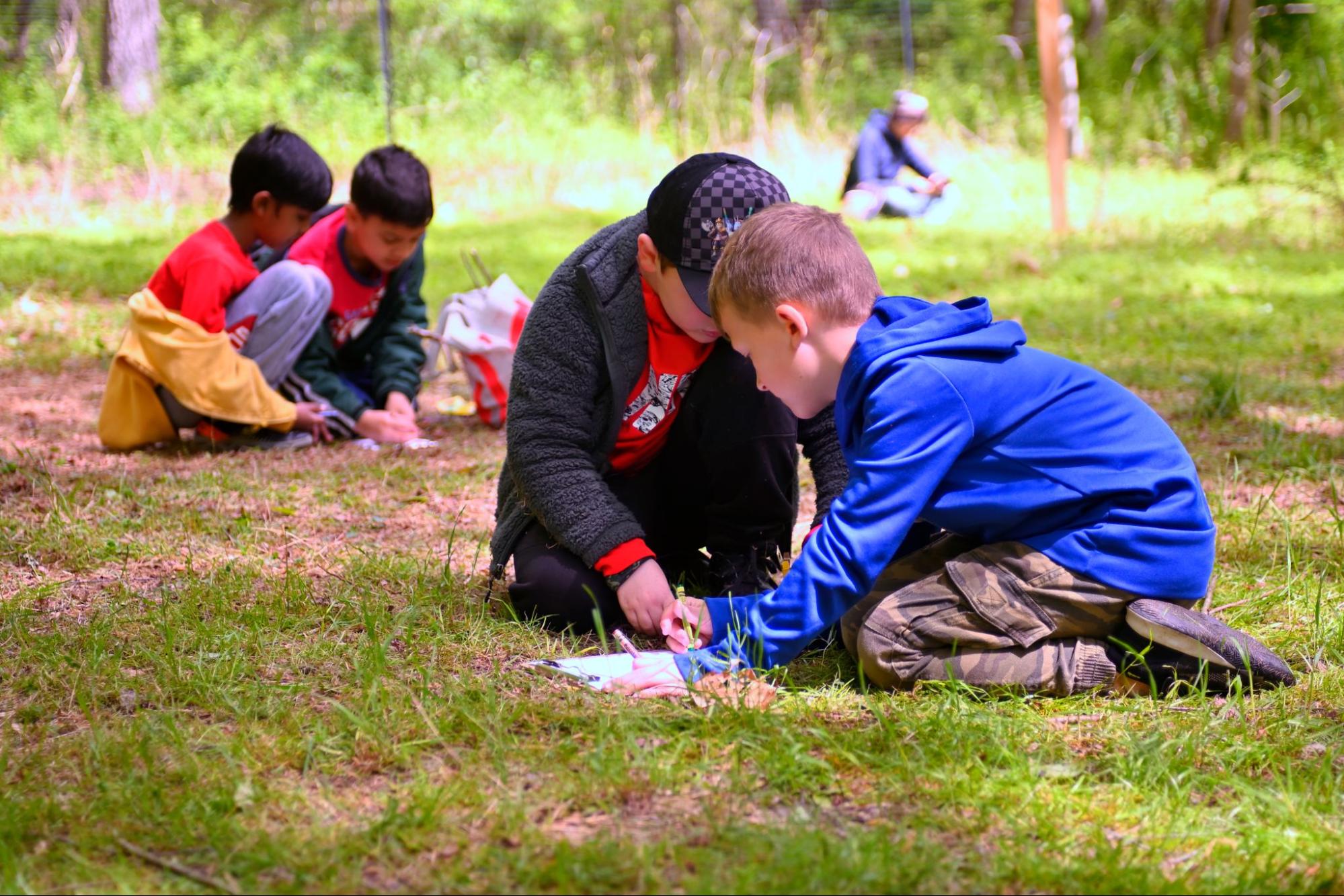 Children taking notes out in the field